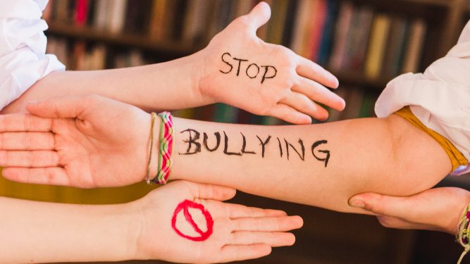 Stop Bullying slogan on children's arms